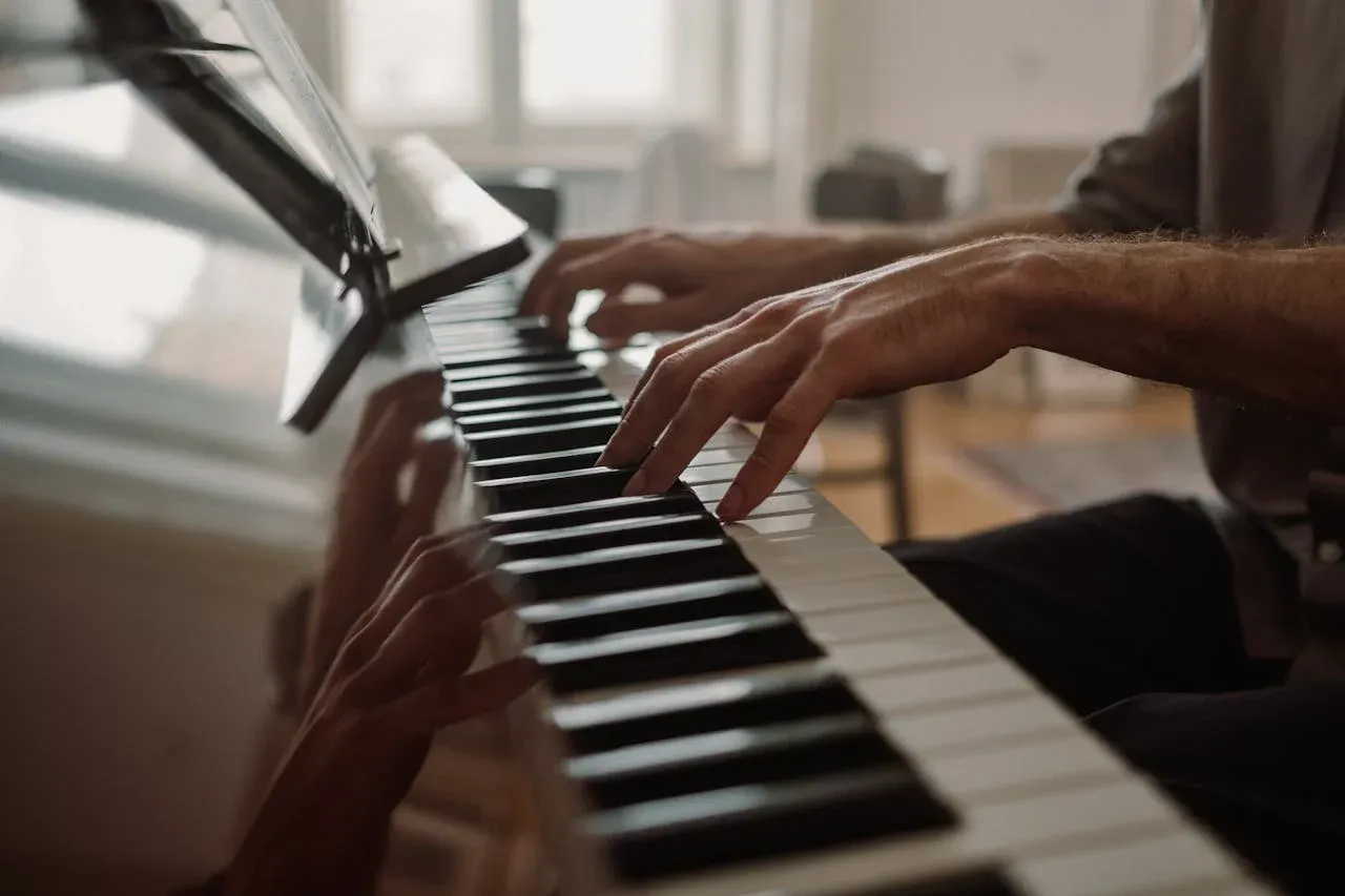 Piano student with their hands on the piano keys